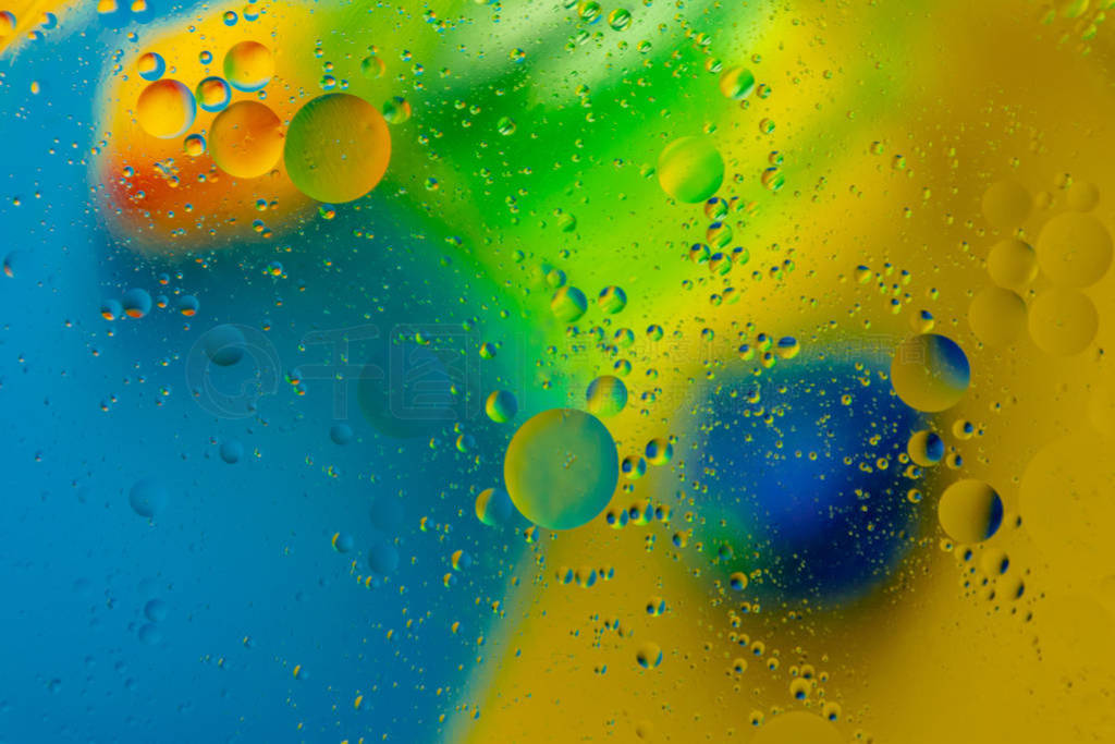 Micro molecular abstract pattern of colored oil bubbles on water