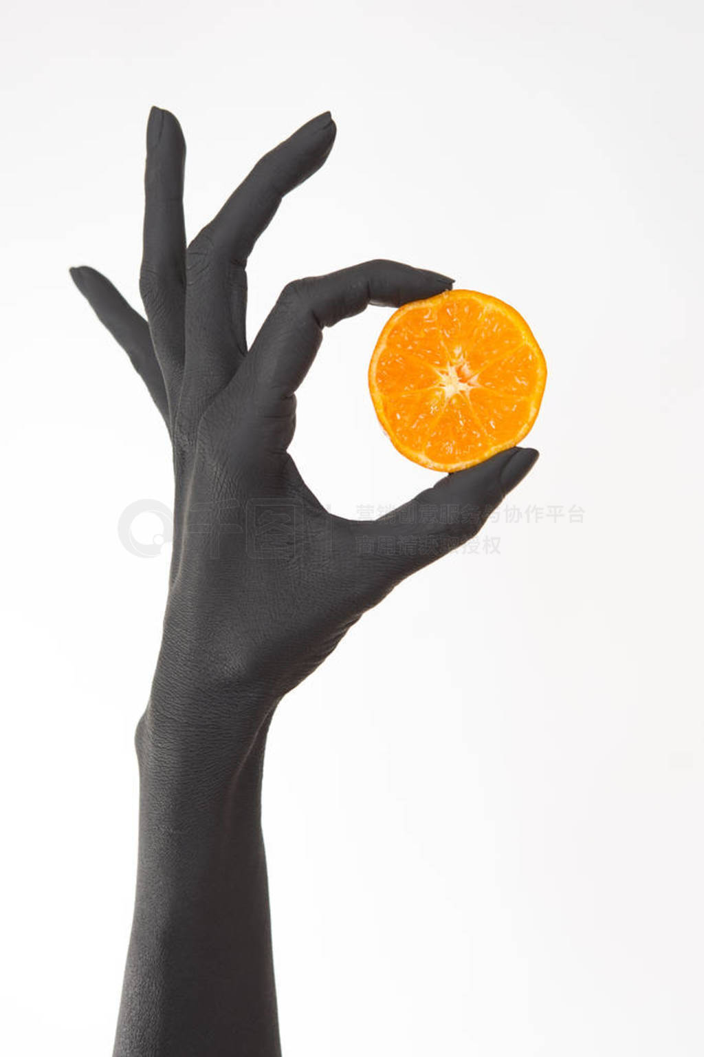 s hands holding orange halves. Black hands with bright tasty man