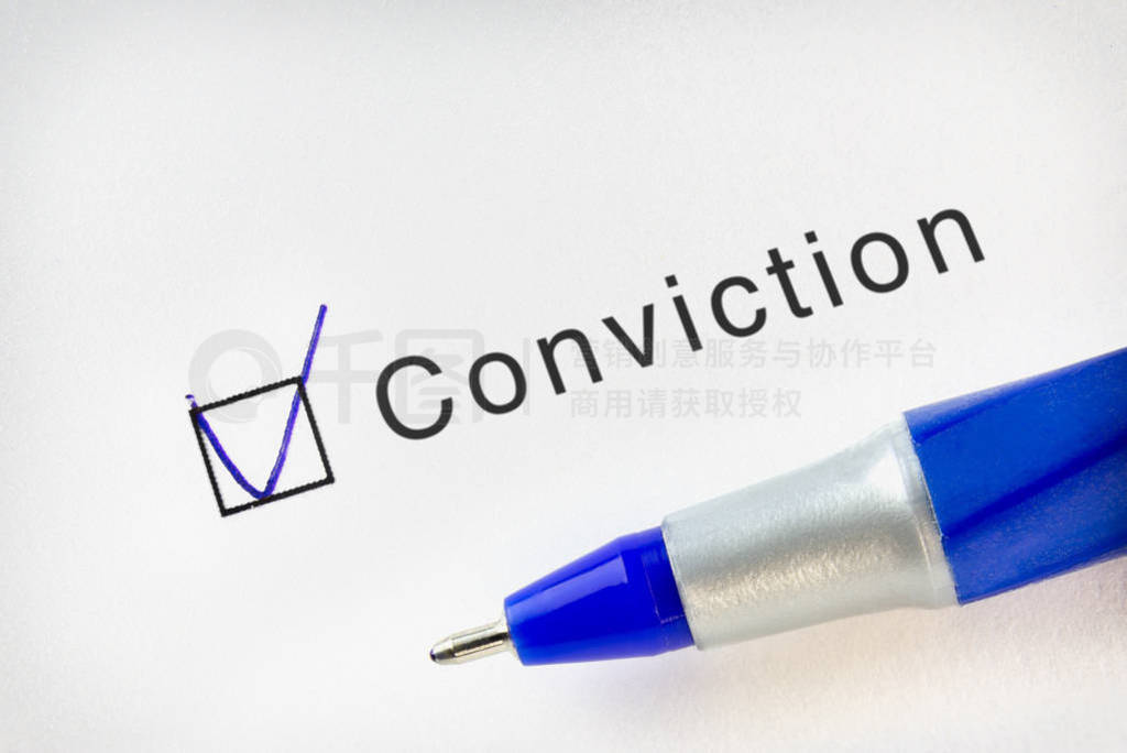 Conviction word in a check list with tick marked and a ball pen