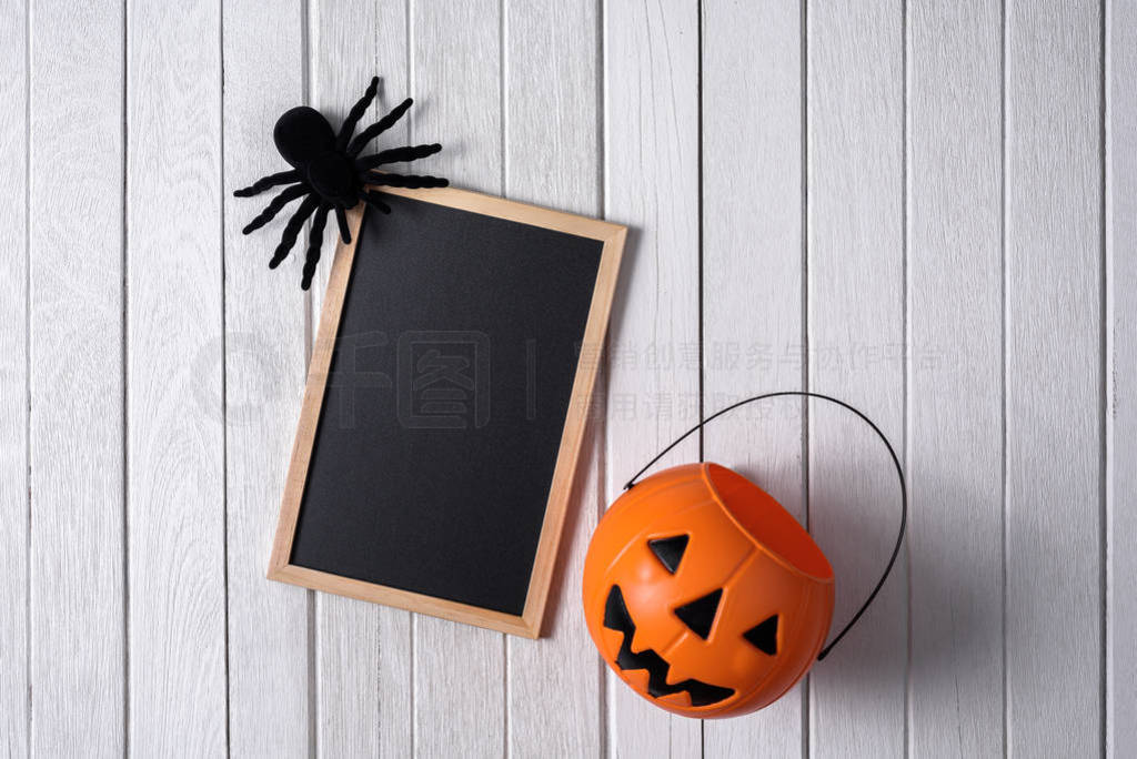 halloween background with Pumpkins, black spider and chalkboard