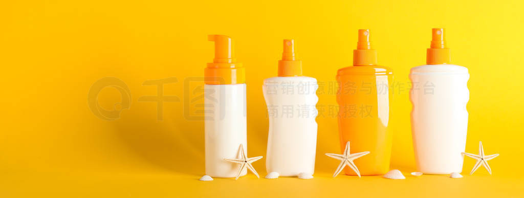 Sunscreen sprays with starfishes on color background, space for