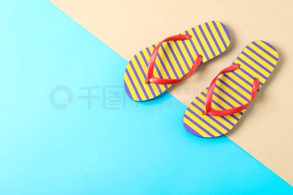 Flip flops on two tone background, space for text and top view.