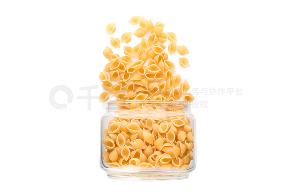 Pasta in glass jar isolated on white background. Uncooked whole