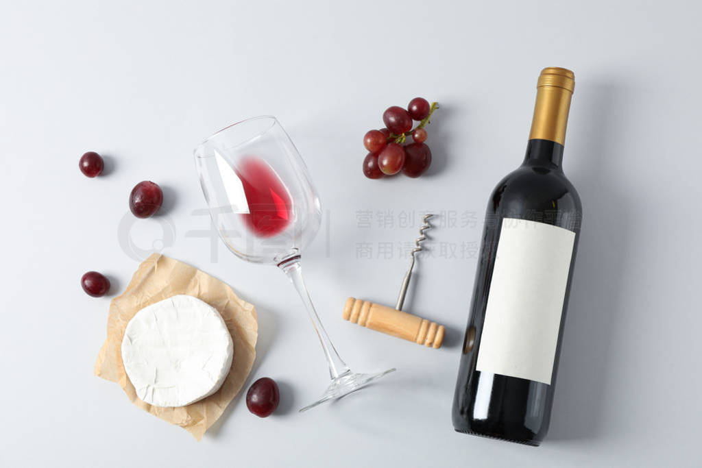 Flat lay. Grapes, cheese, corkscrew, bottle and glass with wine