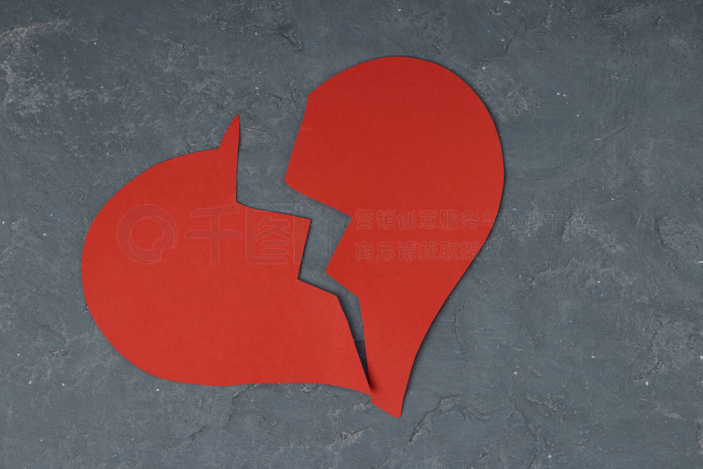 red broken heart on concrete background