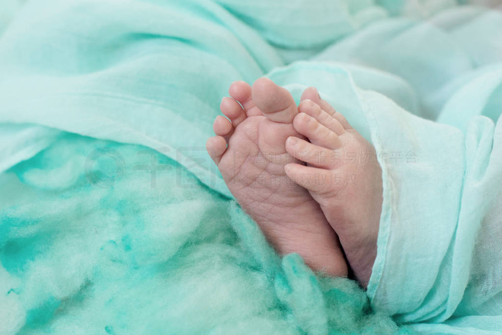 Feet of a newborn baby, toes and nails of a child, the first da