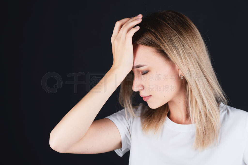 Emotional portrait of a girl holding her head in her hands, feel