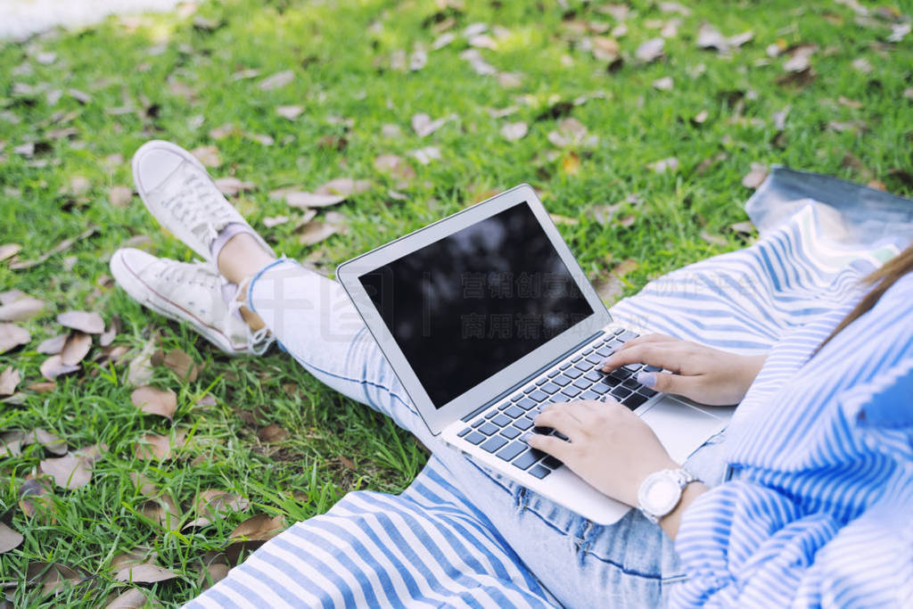 Closeup of people using laptop outdoor in garden with relaxing.