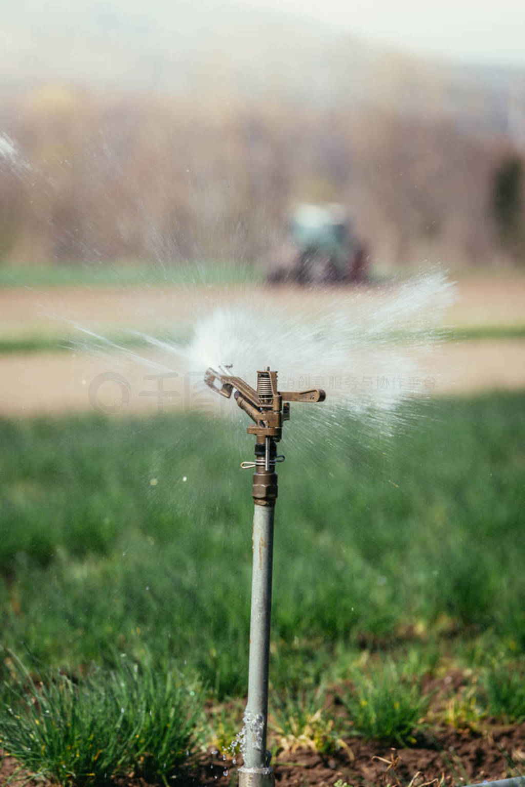 Irrigation plant system on a field, agriculture. Tractor in the