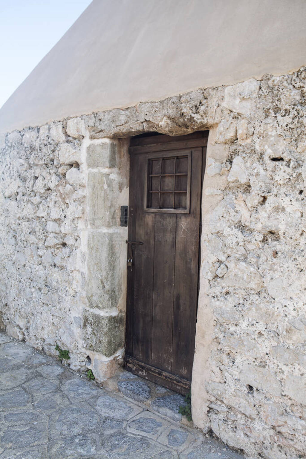 Old medieval wooden door in a stone wall