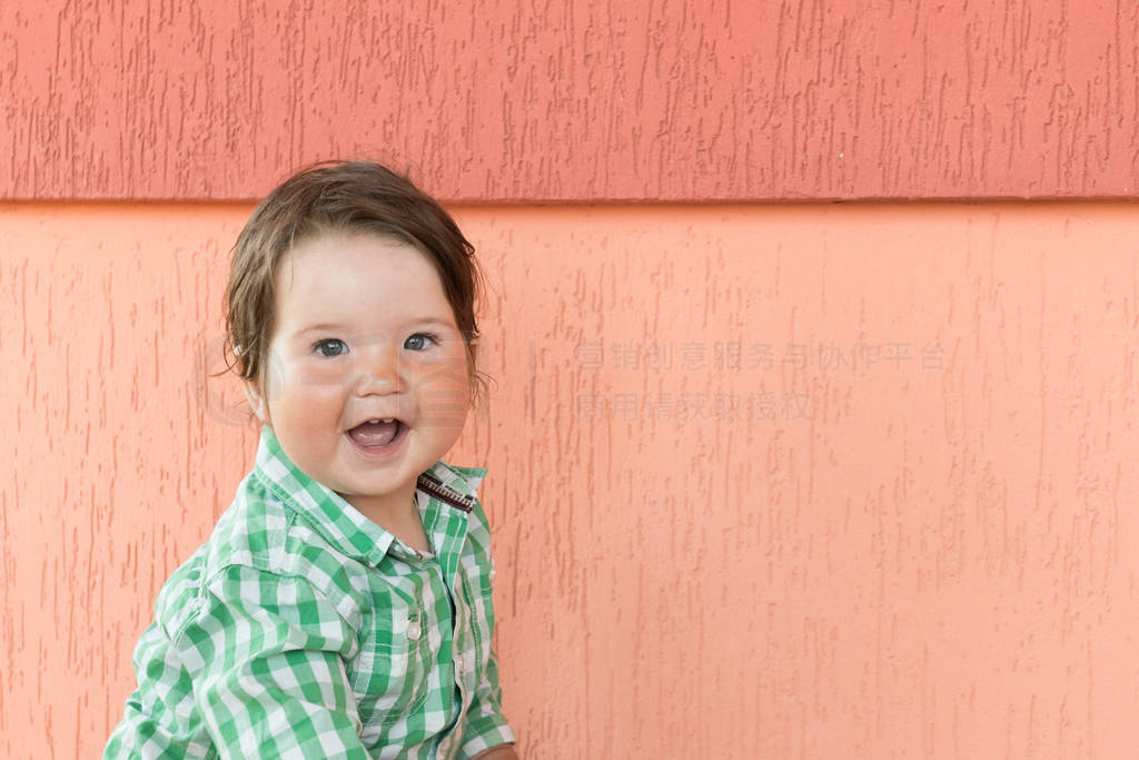 happy baby on a coral background. Head and shoulders portrait of