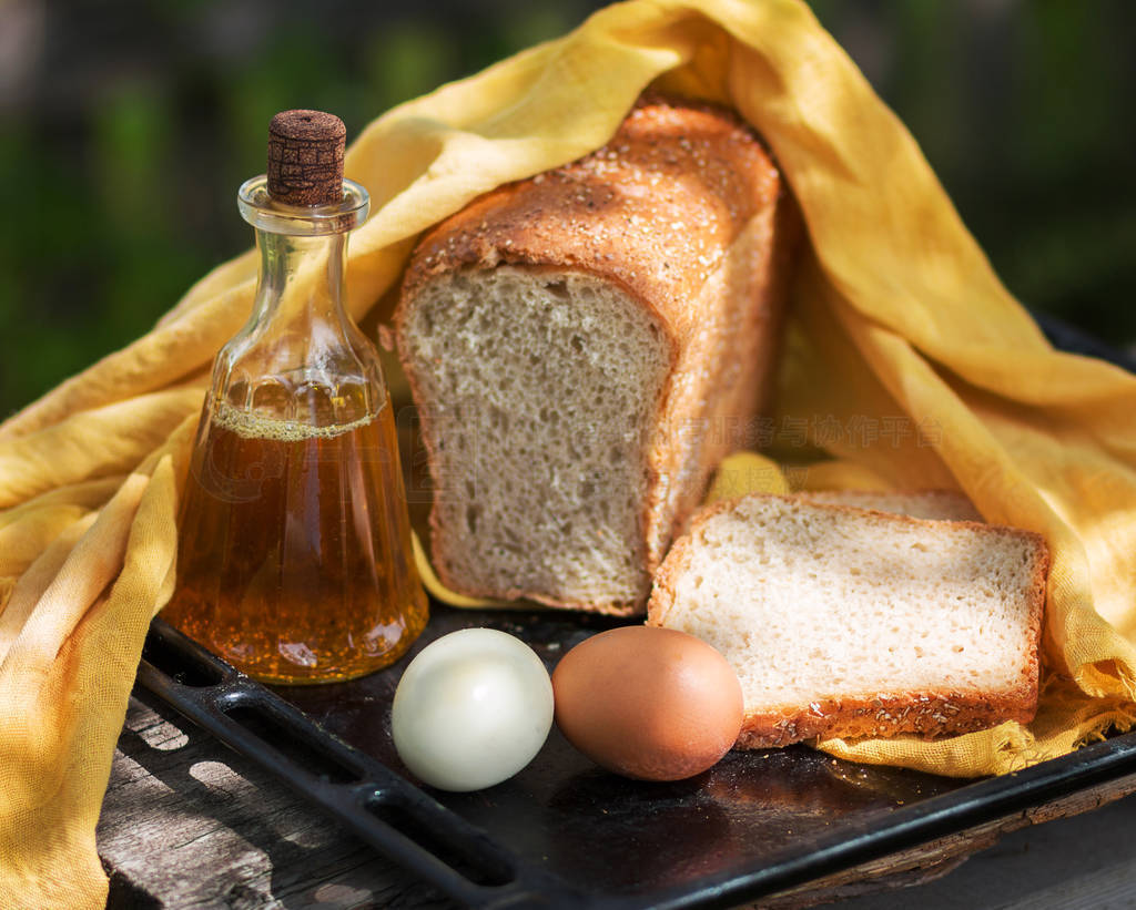 Home-made fresh bread, bottle with sunflower oil, and eggs, on a