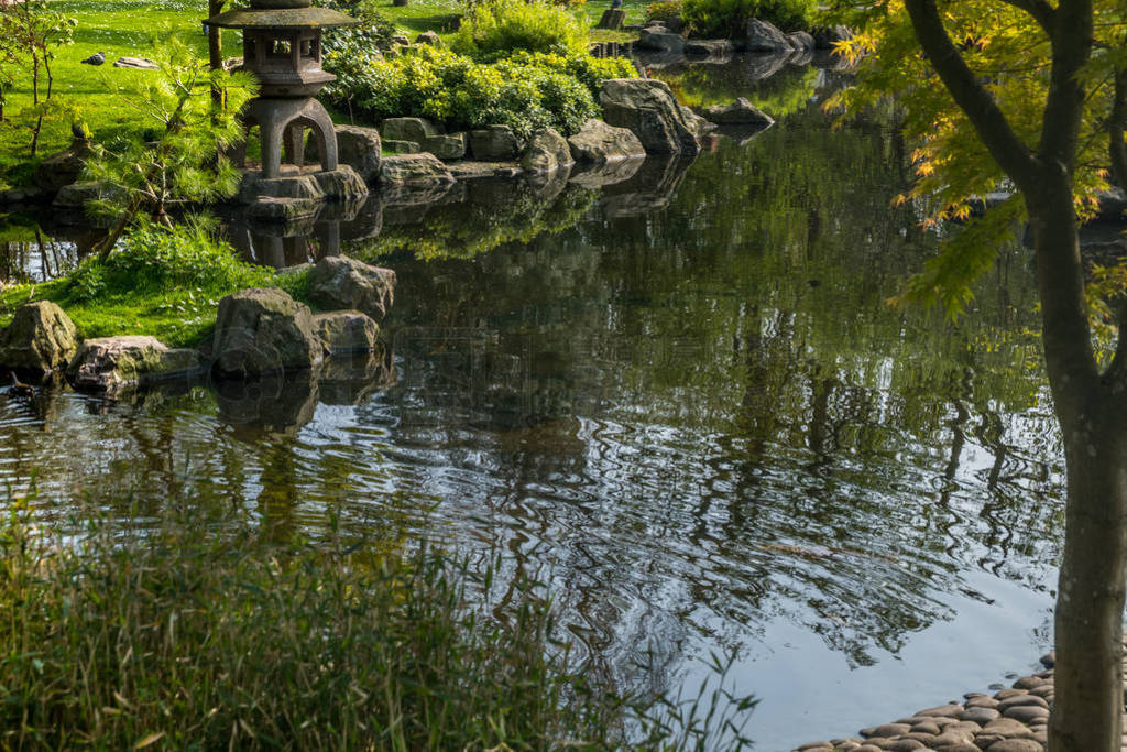 Japanese garden decorated with Japanese stone lanterns, flowers