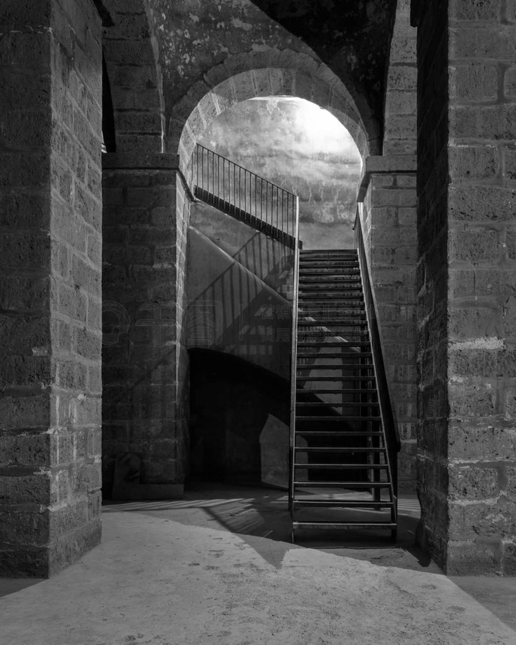 Black and white of dark abandoned underground passage with stone