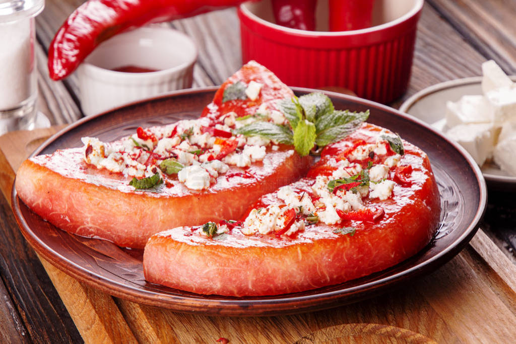 Grilled watermelon with feta cheese, chili pepper and mint. BBQ