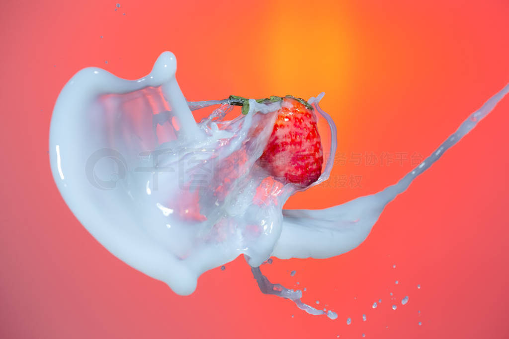 Food Splash Photography. Milk Spills Pouring Around Strawberry.