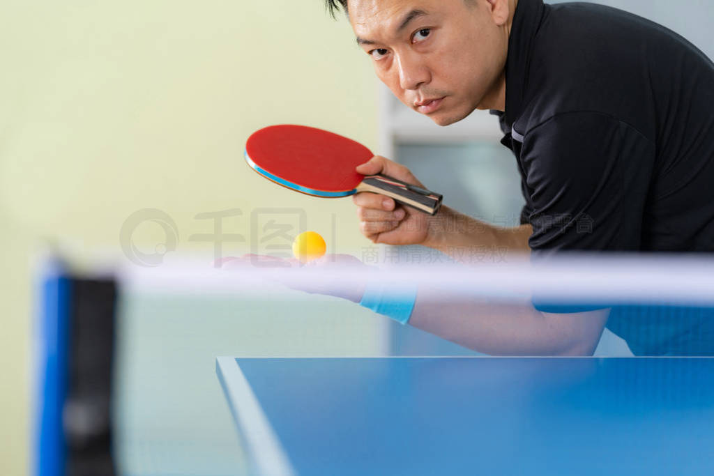 Ping pong table, Male playing table tennis with racket and ball