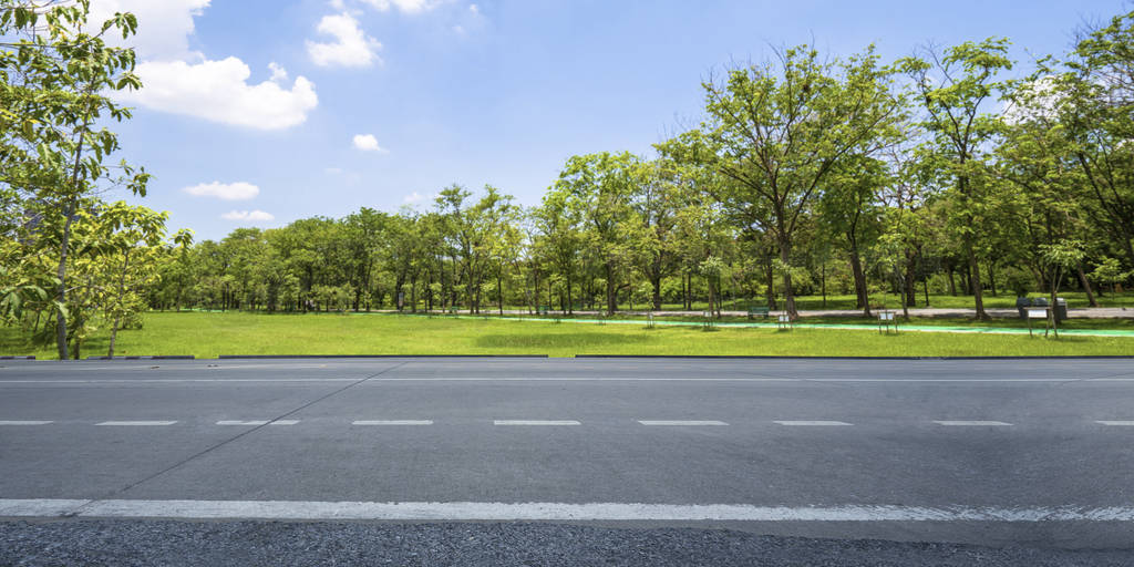 Empty highway asphalt road and beautiful sky in landscape green