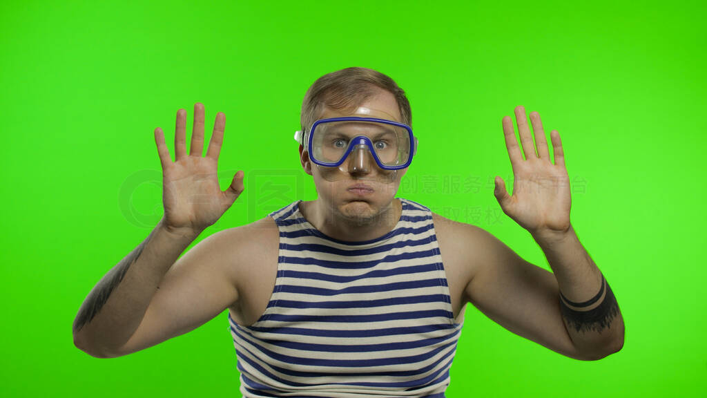 Emotional man tourist in underwater mask, striped sailor shirt o