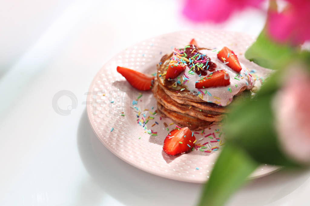 Pink pancakes with strawberries, cottage cheese and colorful su