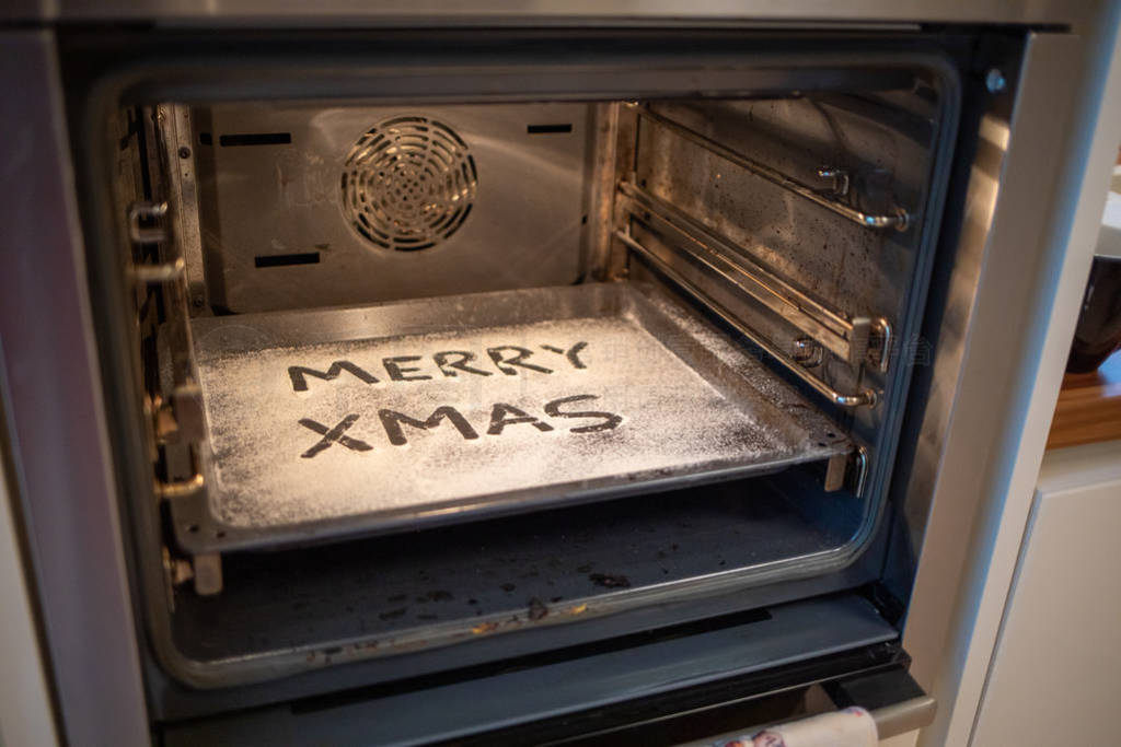 the words Merry Xmas is written on a baking tray sprinkled with