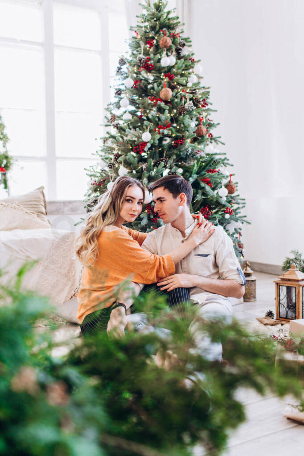 Loving couple gives each other presents for Christmas near the C