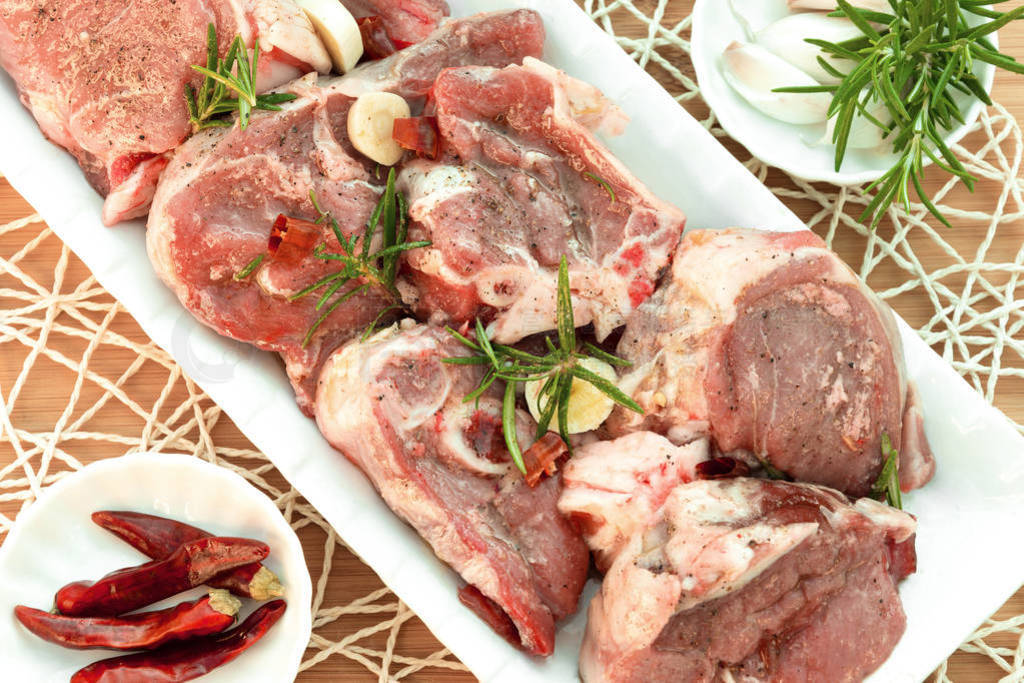 Raw lamb pieces marinated with rosemary, olive oil, garlic and r