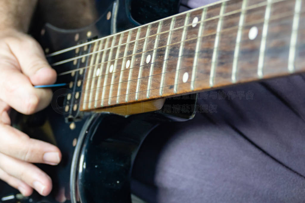 Close-up of man playing lead guitar solo