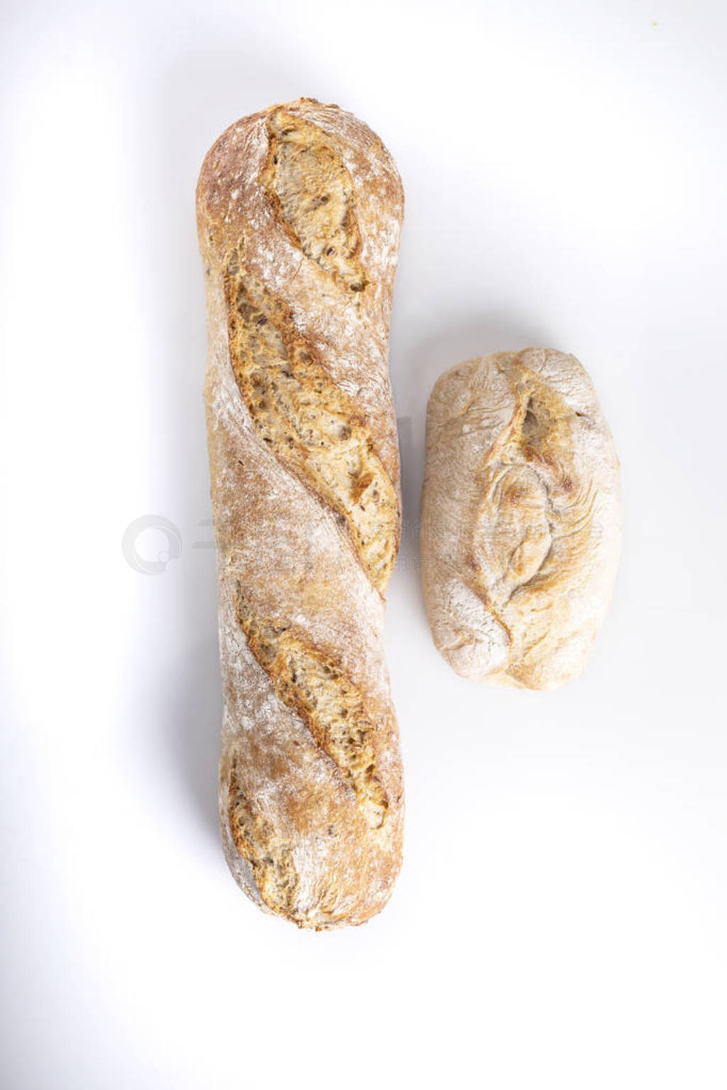 Baguette and wheat roll. Bread on a white background. Traditiona