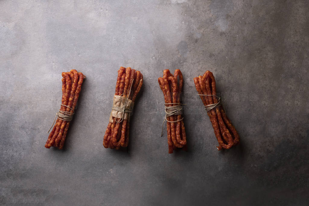 Sausages. Thin sausages on a dark background. Meat snack.