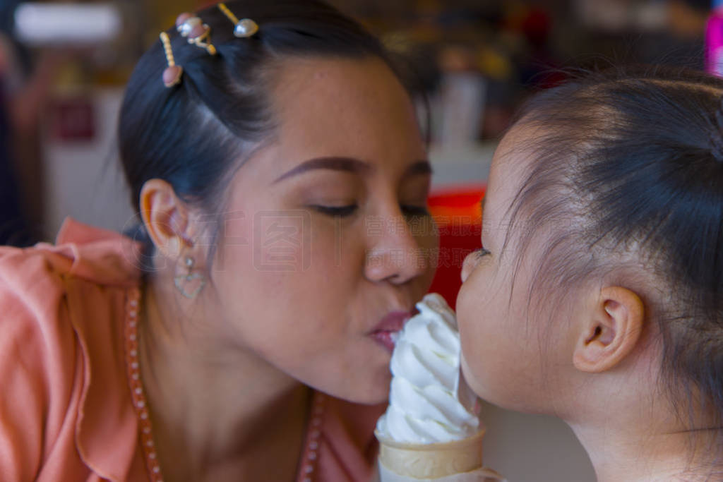 Mom and little child eating ice scream cone together . feeling