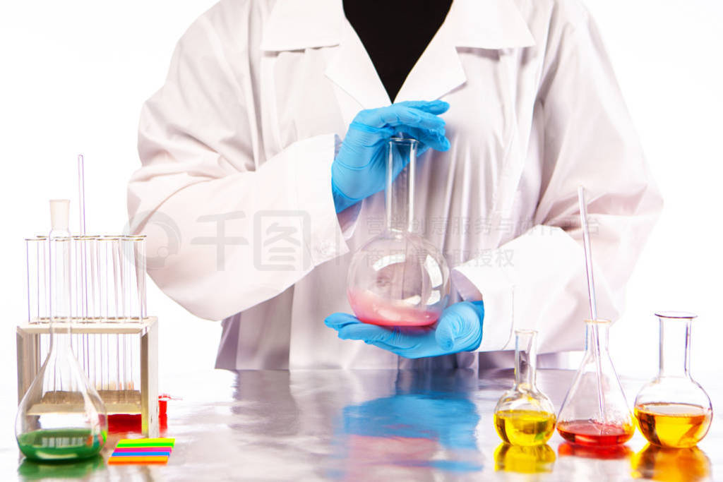 Medical laboratory. The assistant holding a flask with chemical