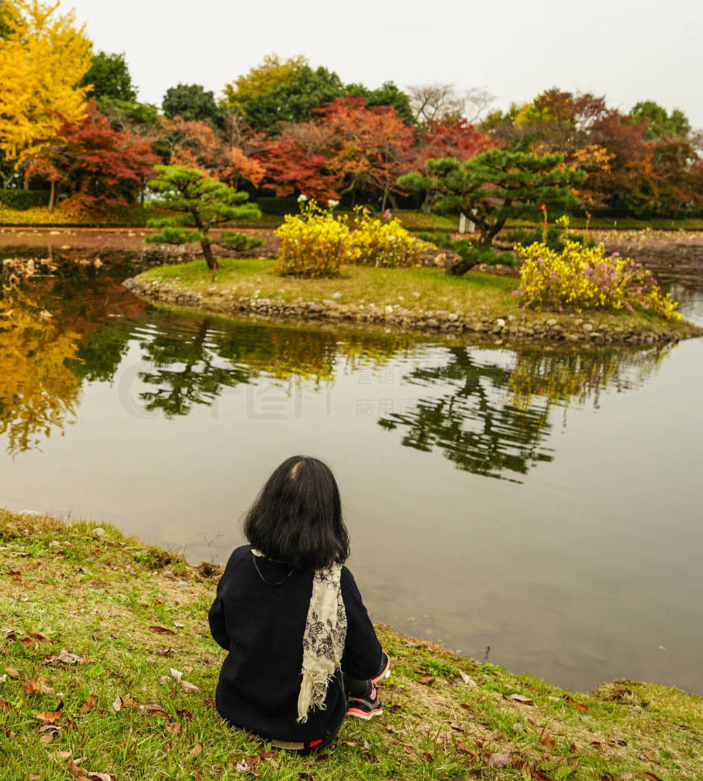 A young woman enjoying at autumn park