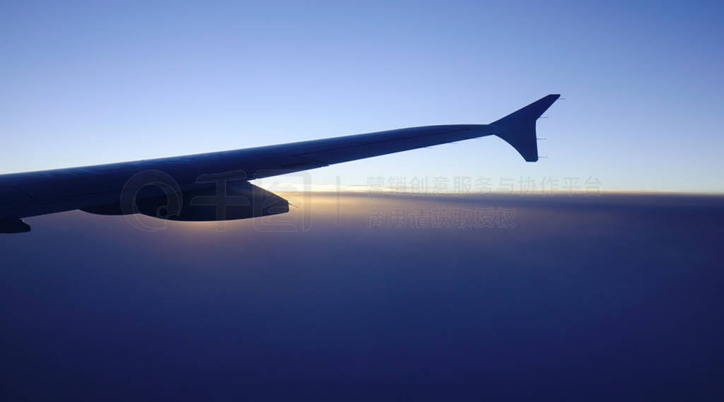Wing of an airplane flying above the clouds