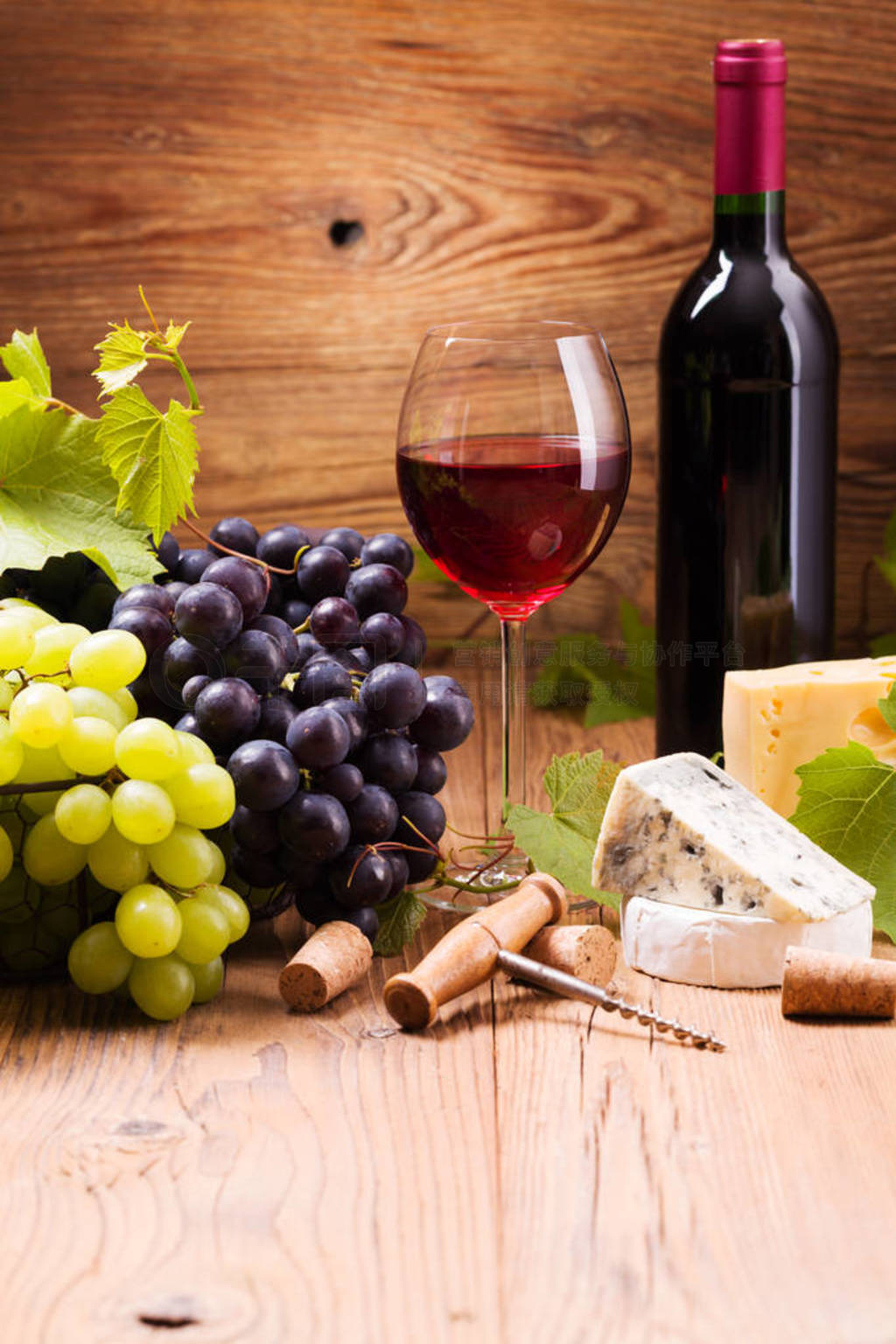 Glass of red wine, served with grapes and cheese