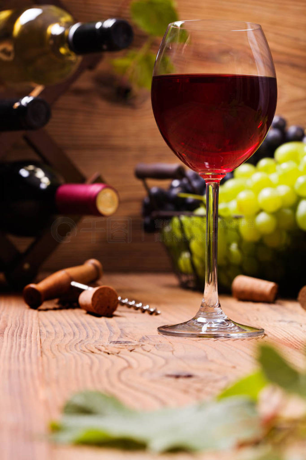 Glass of red wine, served with grapes