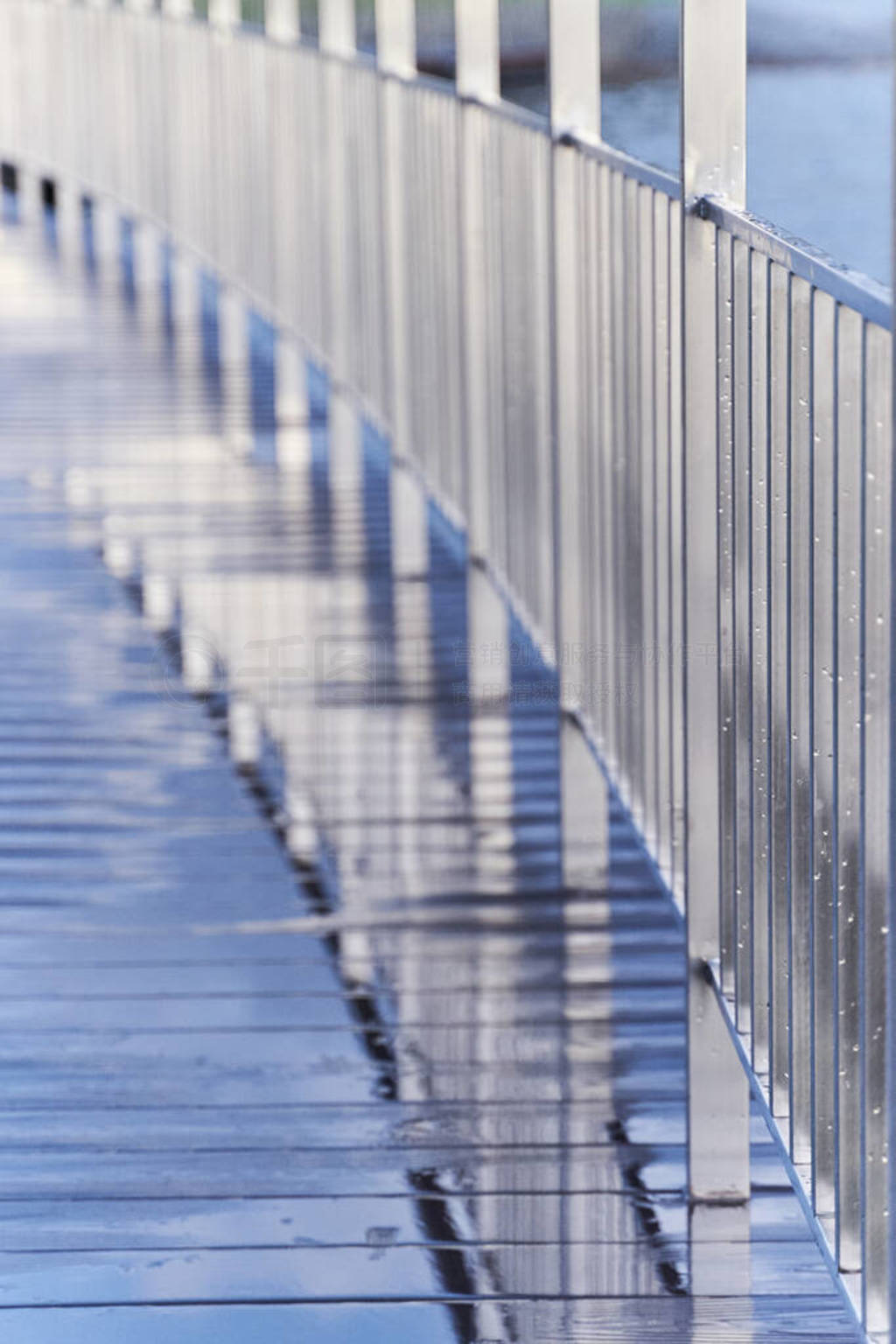 Symmetric straight lines. Reflection of chrome railing in the we