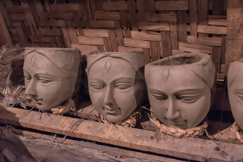 Clay idol face of Goddess Durga, under preparation for