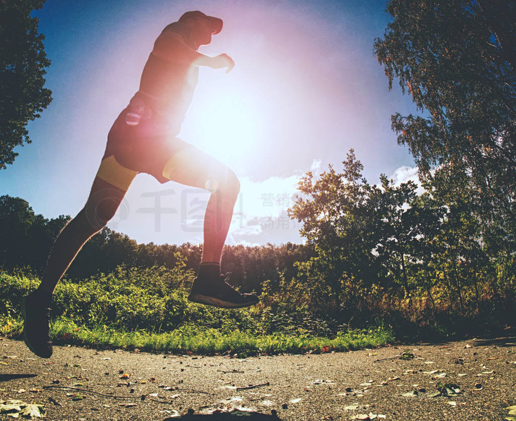 Exigent physical training. The athlete runs fast through alley.