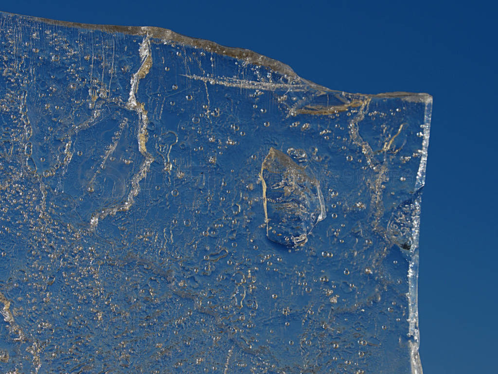 Sun rays caught in cracks in ice piece. Broken floe