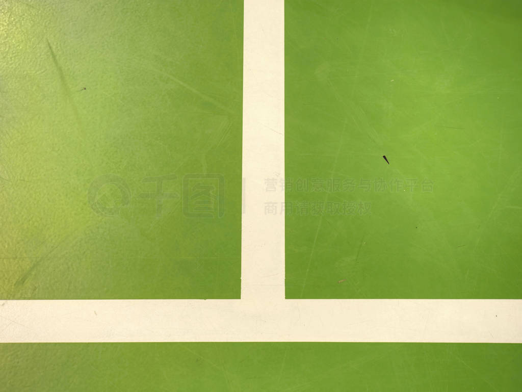 White lines painted on green inside florr. Sporty school hall.