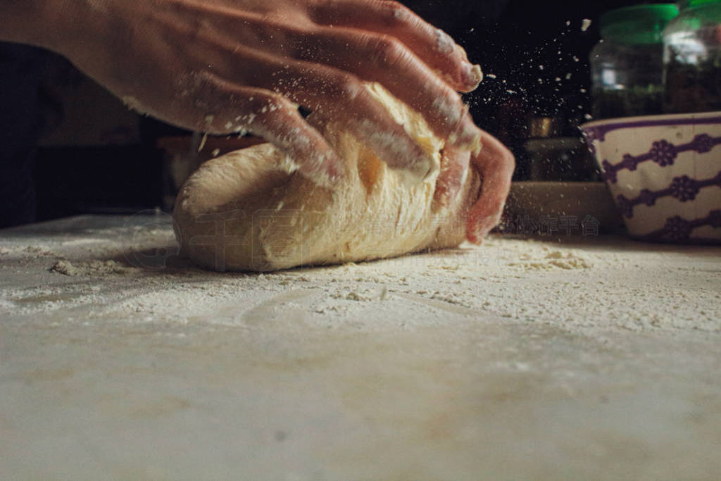 woman's hands knead pizza dough