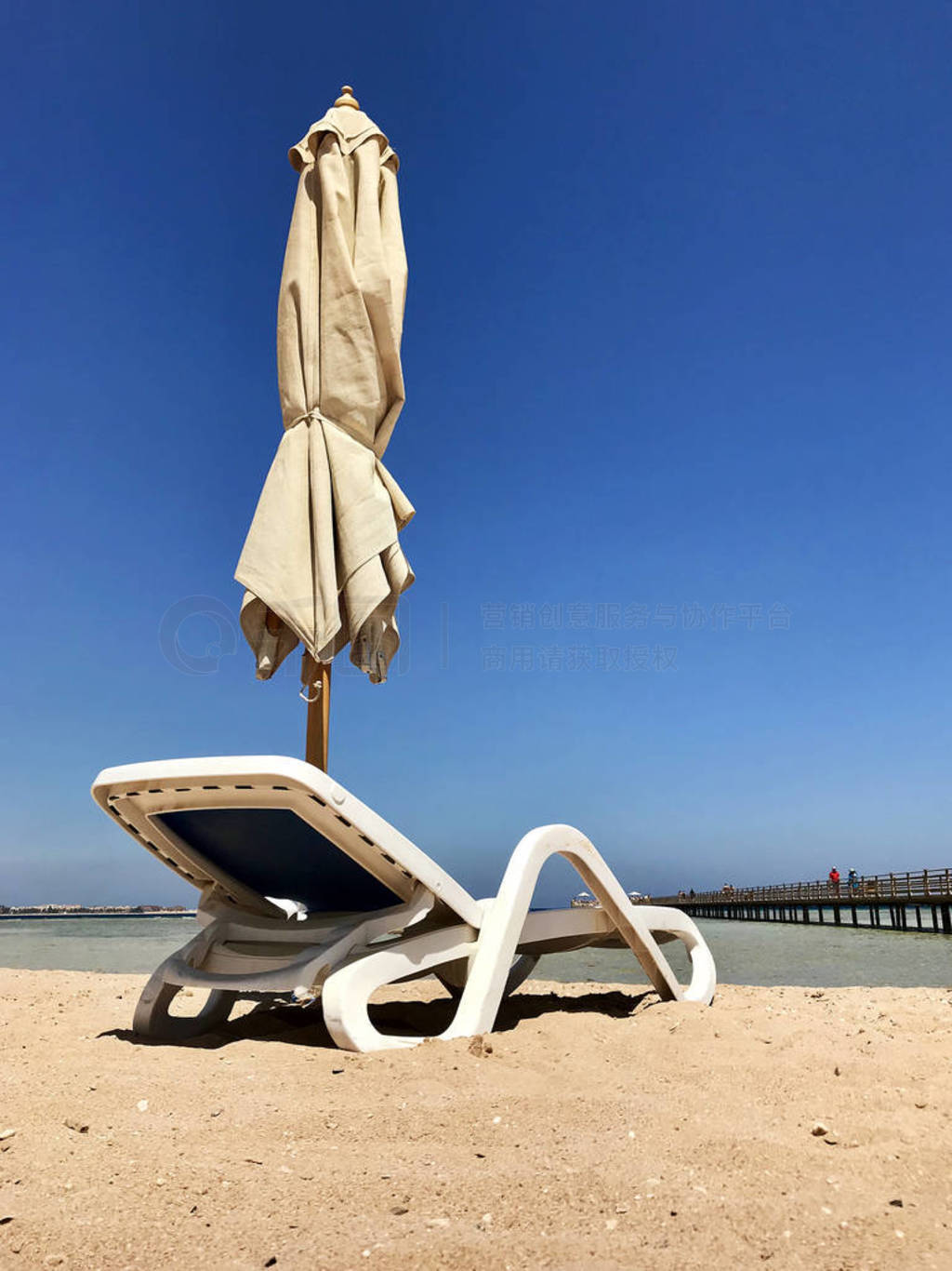Stylish lounger in yellow sand to sun sunbed on beach in summer