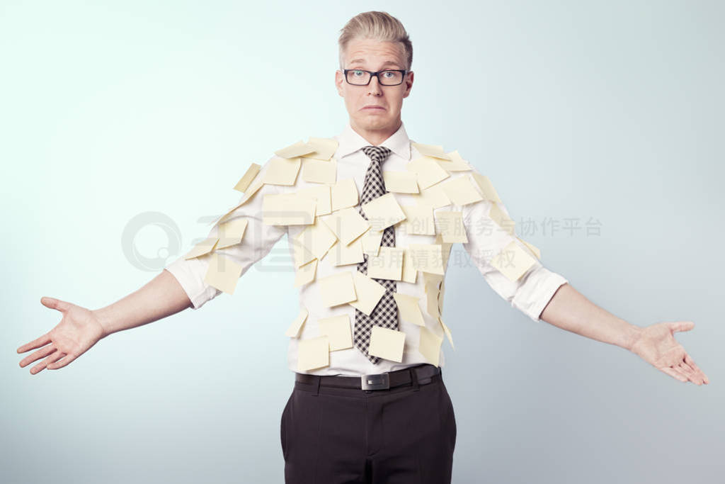 Miserable businessman covered by blank yellow stickers.