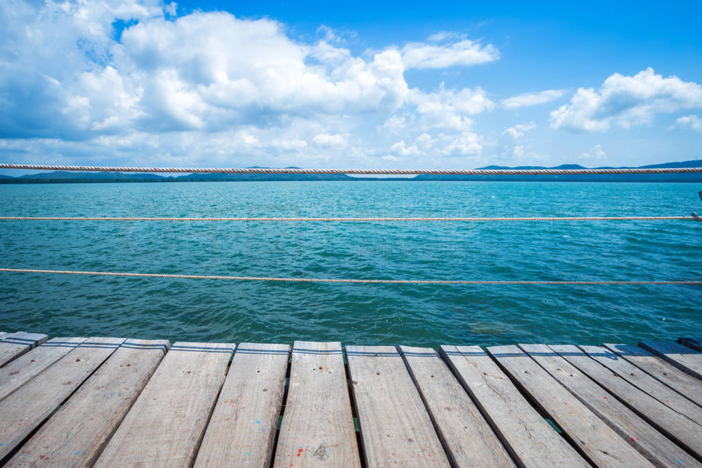 bridge wooden walking way in the sea at Hat chao lao beach blue