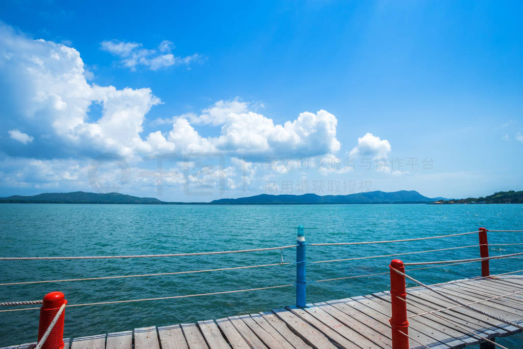 bridge wooden walking way in the sea at Hat chao lao beach blue