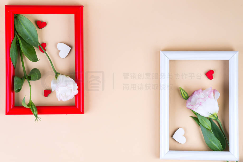 Empty color frames, red hearts and flowers eustoma on beige pape