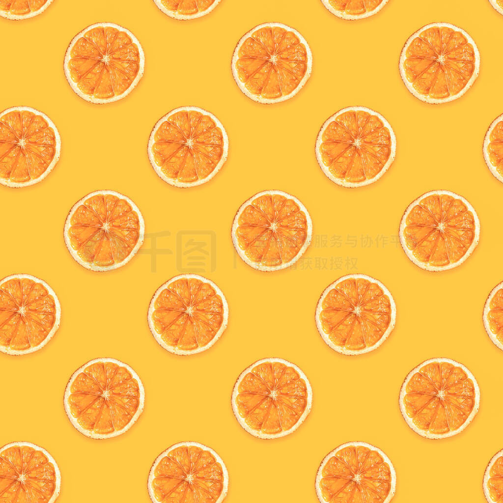 Seamless diagonal pattern of handmade dried orange slices on tre