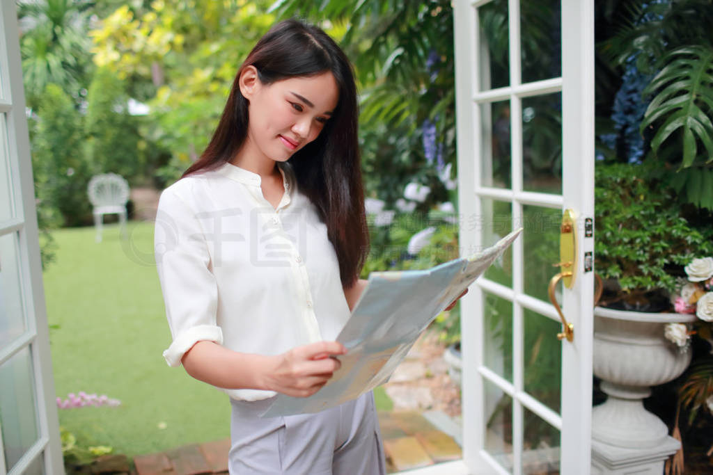 young and cute asian woman searching location in a map during ho