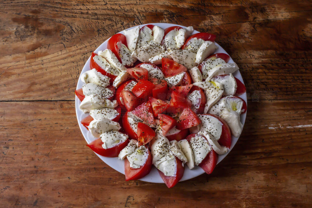 plate with pieces of tomatoes and feta cheese